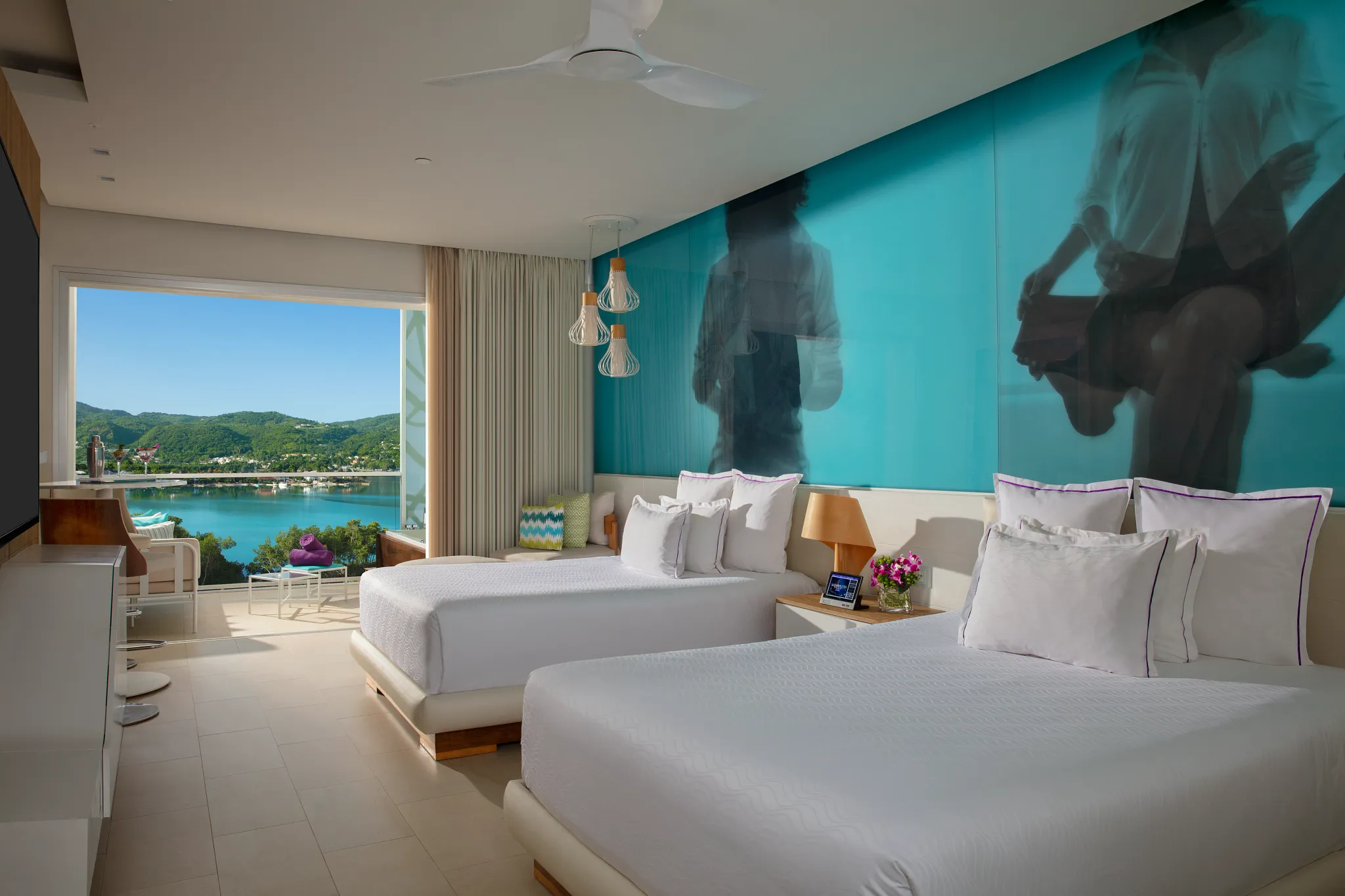 Xhale Club Junior Suite Ocean View at Breathless Montego Bay featuring two double beds, modern décor, and balcony with panoramic ocean and resort views.