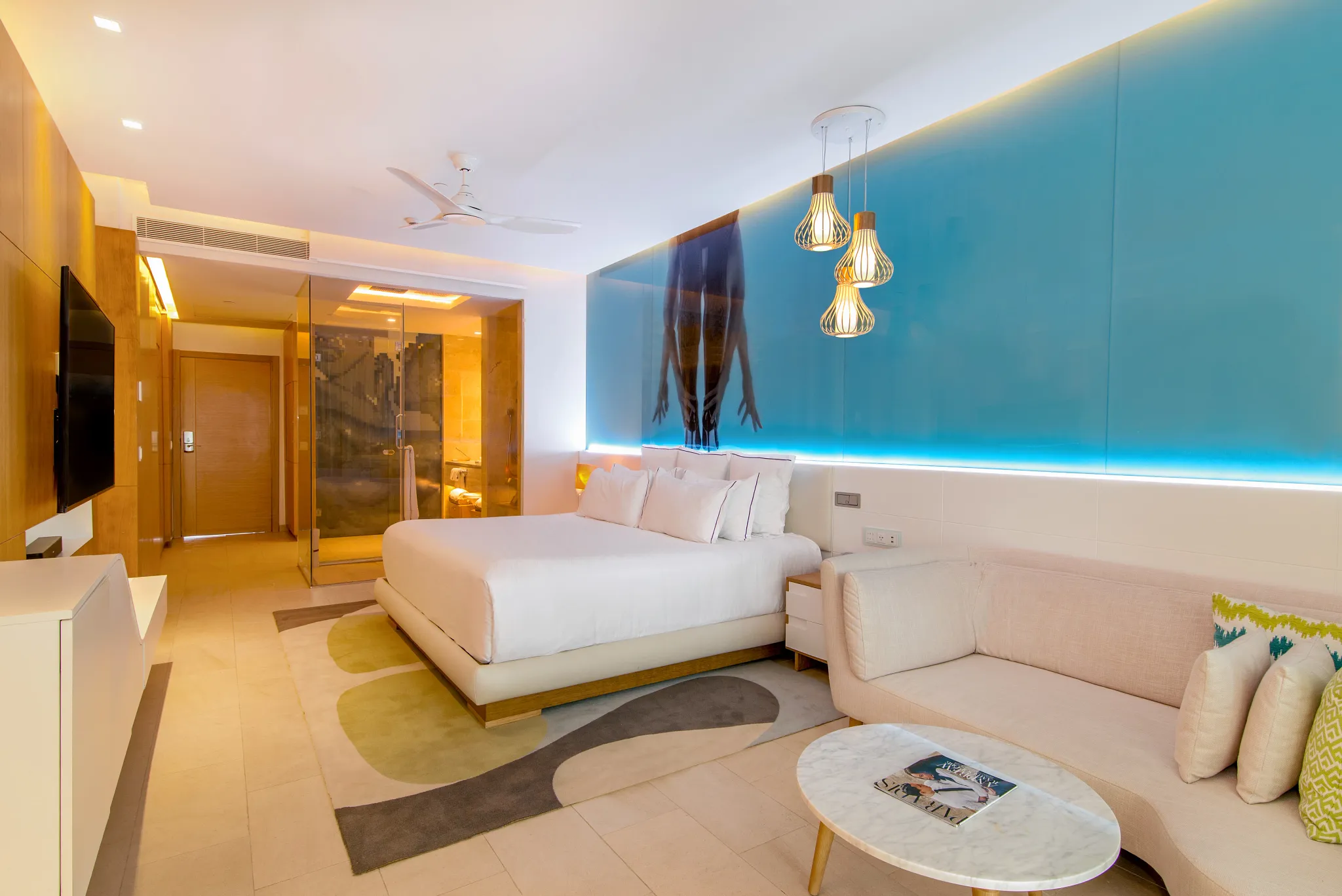 Interior of the Xhale Club Junior Suite Swim Out at Breathless Montego Bay with king bed, seating area, and ambient lighting.